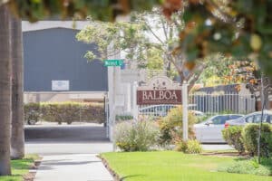 The welcome sign to Balboa behind some trees